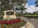 Entrance to the Calusa Lakes community with a sign surrounded by colorful flowers at 2022 Calusa Lakes Blvd, Nokomis, FL 34275