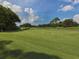 Beautiful golf course featuring well-maintained greens and a scenic view under a partly cloudy sky at 2022 Calusa Lakes Blvd, Nokomis, FL 34275