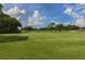 Scenic golf course view showcasing lush green fairways, challenging holes, and mature trees at 2022 Calusa Lakes Blvd, Nokomis, FL 34275