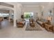 Elegant living room featuring wicker furniture, neutral tones, and a bright view of the pool area at 2022 Calusa Lakes Blvd, Nokomis, FL 34275