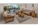Comfortable living room with wicker furniture and a view of the pool through sliding glass doors at 2022 Calusa Lakes Blvd, Nokomis, FL 34275