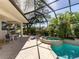 Screened-in pool and spa area surrounded by lush tropical landscaping at 2022 Calusa Lakes Blvd, Nokomis, FL 34275