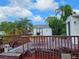 Wooden back deck with outdoor seating and lush tropical surroundings at 205 Jessica N St, Nokomis, FL 34275