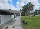 Exterior of the home with a concrete walkway, manicured lawn, and tropical landscaping at 205 Jessica N St, Nokomis, FL 34275
