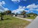 A view of the front yard and home, showcasing the lawn, landscaping, and exterior at 205 Jessica N St, Nokomis, FL 34275