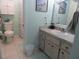 Bathroom with a vanity and a shower with patterned curtains at 211 High Point Dr # 211B, Englewood, FL 34223