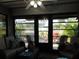 Enclosed lanai with comfortable seating offering a relaxing outdoor space at 211 High Point Dr # 211B, Englewood, FL 34223