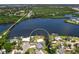 Stunning aerial view of a waterfront property on a river with a bridge visible in the distance at 214 Pompano Ln, Nokomis, FL 34275