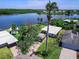 Aerial view showcasing a waterfront home with private dock, spacious yard, and lush surroundings at 214 Pompano Ln, Nokomis, FL 34275