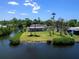 Desirable waterfront property with lush landscaping and a private waterfront perfect for relaxation and enjoying sunsets at 214 Pompano Ln, Nokomis, FL 34275