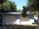 A detached two-car garage with white doors and blue painted walls at 2682 Yamada Ln, North Port, FL 34286