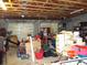 Open garage filled with boxes and stored contents at 2682 Yamada Ln, North Port, FL 34286