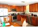 Kitchen featuring stainless appliances, granite counters and wood cabinets at 2682 Yamada Ln, North Port, FL 34286
