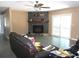 Large living room featuring a decorative tiled fireplace and neutral colored walls at 2682 Yamada Ln, North Port, FL 34286