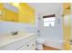 Bathroom featuring single sink vanity, and shower with yellow painted walls at 2980 Siesta Dr, Venice, FL 34293