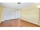 Bright bedroom with hardwood floors, closet, and doorway to other rooms at 2980 Siesta Dr, Venice, FL 34293