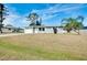 A charming one-story home with a well-maintained lawn, attached garage, and modern windows at 2980 Siesta Dr, Venice, FL 34293