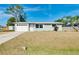 Charming one-story home with a well-maintained lawn, attached garage, and modern windows at 2980 Siesta Dr, Venice, FL 34293