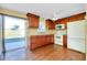 Traditional kitchen with wood cabinets, appliances, and sliding glass doors to the outdoor patio at 2980 Siesta Dr, Venice, FL 34293