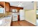 Bright kitchen with wooden cabinets, granite countertops, and stainless sink at 2980 Siesta Dr, Venice, FL 34293