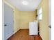 Utility room with washer and dryer, white door and yellow walls at 2980 Siesta Dr, Venice, FL 34293