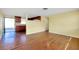 Open living space with hardwood floors, flowing into a kitchen area with wood cabinets at 2980 Siesta Dr, Venice, FL 34293