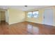 Living area featuring hardwood floors, natural light, and convenient access to an exterior door at 2980 Siesta Dr, Venice, FL 34293