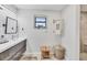 Bright bathroom featuring a modern vanity, framed mirror, and walk-in shower with neutral tiles at 307 Bucknell Rd, Venice, FL 34293