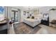 Bright bedroom features modern decor, plenty of natural light, and wood-look flooring at 307 Bucknell Rd, Venice, FL 34293