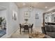 Open dining room features a modern light fixture, decor, and seating for four at 307 Bucknell Rd, Venice, FL 34293