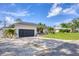 Home featuring an attached garage and a long concrete driveway at 307 Bucknell Rd, Venice, FL 34293