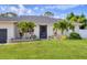 Inviting front entrance with lush landscaping and a well-manicured lawn at 307 Bucknell Rd, Venice, FL 34293