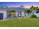 Inviting front entrance with lush landscaping and a well-manicured lawn at 307 Bucknell Rd, Venice, FL 34293