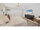 Cozy main bedroom features a comfortable bed, modern lighting, and light walls at 307 Bucknell Rd, Venice, FL 34293