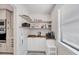 Bright pantry with open shelving, white cabinets, coffee maker, and wood countertop at 307 Bucknell Rd, Venice, FL 34293