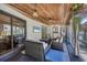 Relaxing covered patio with comfortable seating, ceiling fan, TV, and stylish decor, perfect for outdoor entertaining at 307 Bucknell Rd, Venice, FL 34293