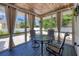 Cozy screened porch with an outdoor dining area and views of the backyard at 307 Bucknell Rd, Venice, FL 34293