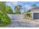 Gated side yard with landscaping and privacy fence offering a secure and private outdoor space at 307 Bucknell Rd, Venice, FL 34293