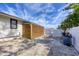 The side yard features attractive wood slat structure, gravel, a gate and trash cans at 307 Bucknell Rd, Venice, FL 34293
