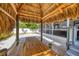 Backyard tiki hut with a picnic table offering a shaded spot for outdoor gatherings and casual dining at 307 Bucknell Rd, Venice, FL 34293