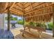 Charming tiki hut with a picnic table, set in a serene backyard, perfect for outdoor dining and relaxation at 307 Bucknell Rd, Venice, FL 34293