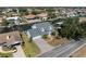 Aerial view of a waterfront home with a canal, a paved driveway and a two-car garage at 318 Oakwood Cir, Englewood, FL 34223