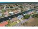 Scenic aerial view showcasing canal-front homes, lush landscaping, and peaceful waterfront living at 318 Oakwood Cir, Englewood, FL 34223