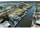 Aerial shot showcasing a home with a pool on a canal, providing private waterfront living with a boat lift at 318 Oakwood Cir, Englewood, FL 34223