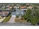 Aerial view showcasing a well-maintained waterfront property in a residential neighborhood with a private canal at 318 Oakwood Cir, Englewood, FL 34223