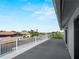 Balcony featuring white railings and providing waterfront views of the canal and surrounding homes at 318 Oakwood Cir, Englewood, FL 34223