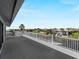 Wide balcony overlooking a serene canal with waterfront views of nearby homes and palm trees at 318 Oakwood Cir, Englewood, FL 34223