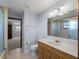 Bathroom with a vanity, toilet, and shower with glass door and tile surround at 318 Oakwood Cir, Englewood, FL 34223