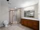 Updated bathroom featuring a walk-in shower with a vanity and tiled flooring at 318 Oakwood Cir, Englewood, FL 34223