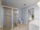 Tiled bathroom featuring a glass enclosed shower, toilet, and a vanity with modern finishes at 318 Oakwood Cir, Englewood, FL 34223